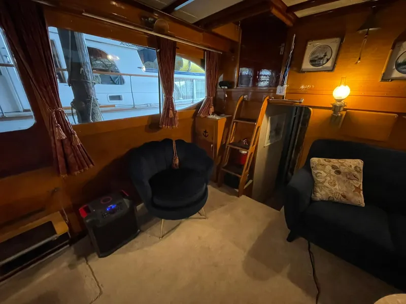 Slide: The Image of Interior of a 1951 Chris-Craft Catalina boat with cozy seating and vintage decor. - 8
