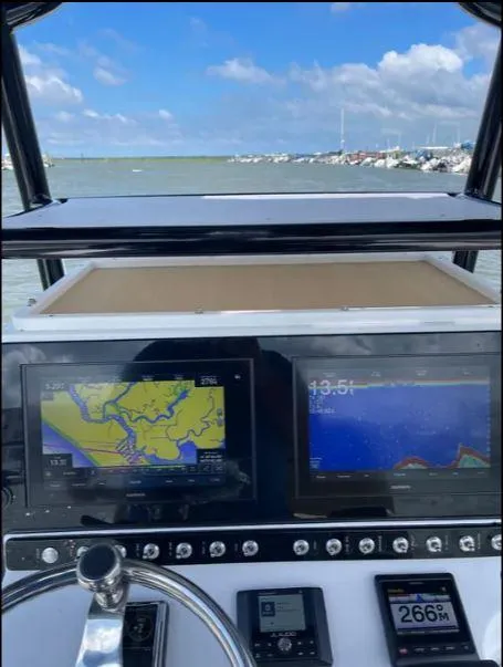 Slide: The Image of 2021 Sportsman MASTERS 247 BAY boat dashboard with navigation screens and controls. - 3