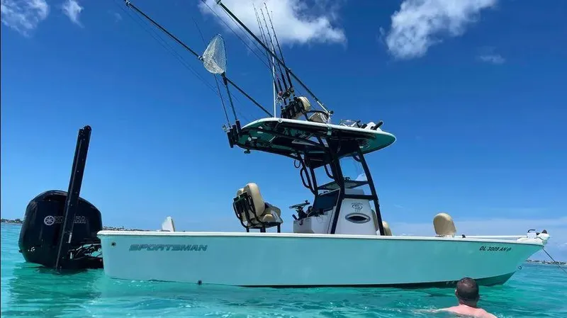 Slide: The Image of 2021 Sportsman MASTERS 247 BAY boat on clear blue water, fishing rods visible. - 7