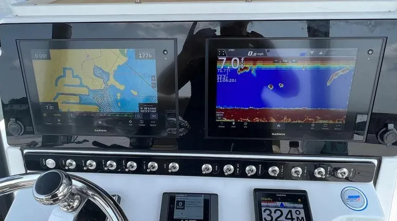Slide: The Image of 2021 Sportsman MASTERS 247 BAY boat dashboard with dual Garmin navigation screens. - 8