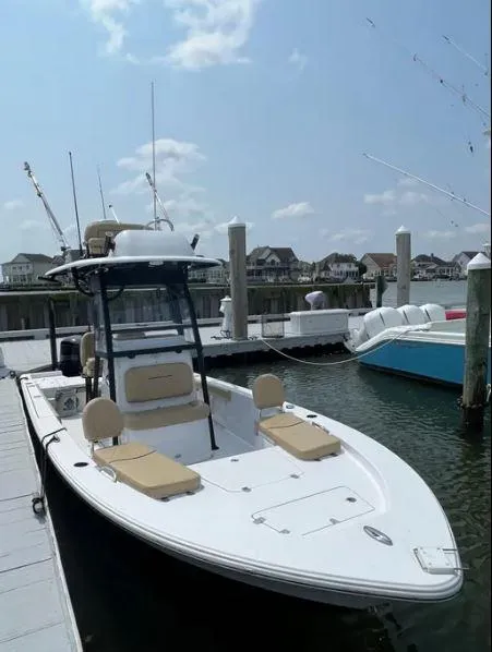 Slide: The Image of 2021 Sportsman MASTERS 247 BAY boat docked at marina under clear sky. - 9