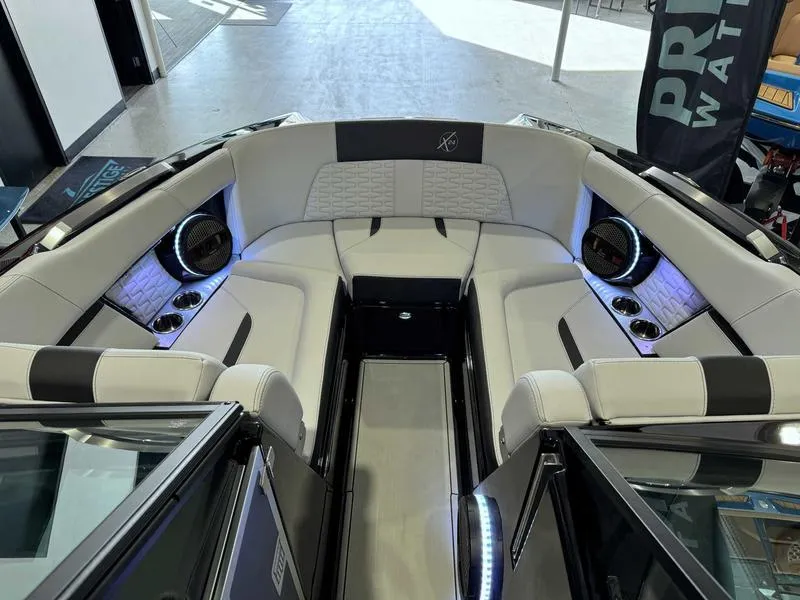 Slide: The Image of 2024 MasterCraft X24 boat interior with luxurious seating and ambient lighting. - 10