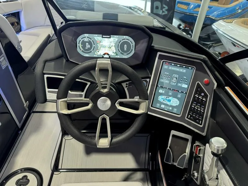 Slide: The Image of 2024 MasterCraft X24 boat dashboard with advanced digital controls and steering wheel. - 11