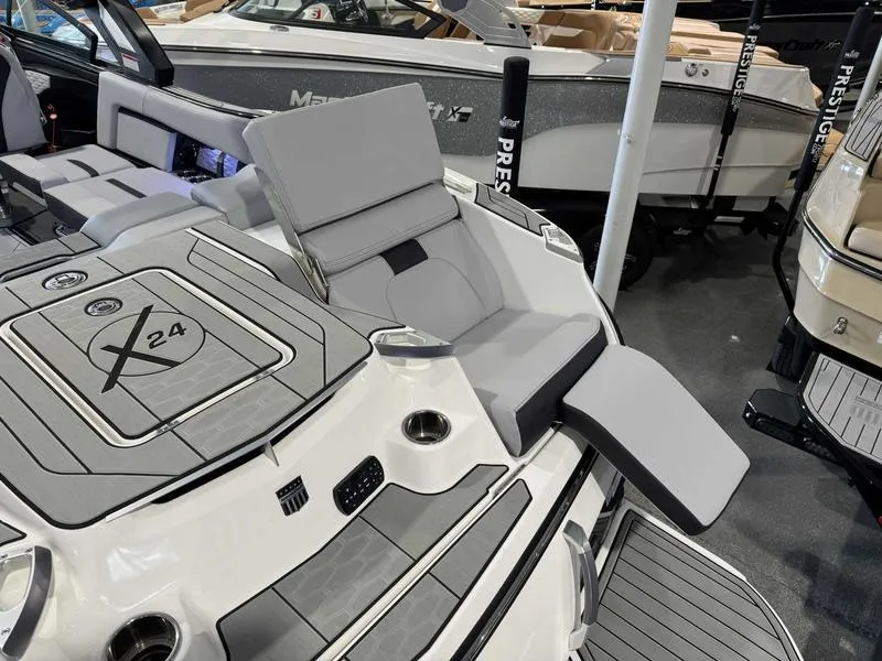 Slide: The Image of 2024 MasterCraft X24 boat interior with luxurious seating and sleek design. - 13