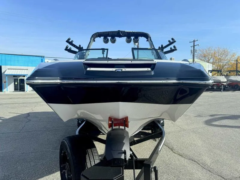 Slide: The Image of 2024 MasterCraft X24 boat on trailer, front view, outdoors. - 2