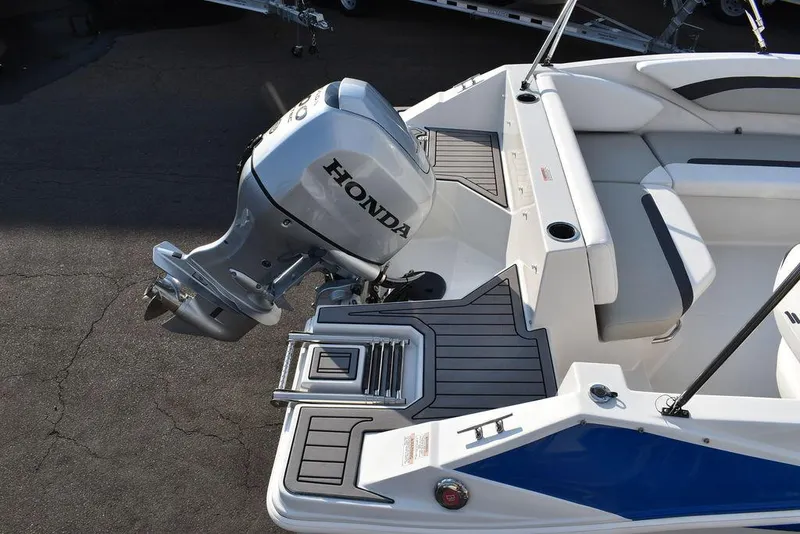 Slide: The Image of 2022 Starcraft SVX 171 boat with Honda outboard motor, featuring sleek seating and deck design. - 11