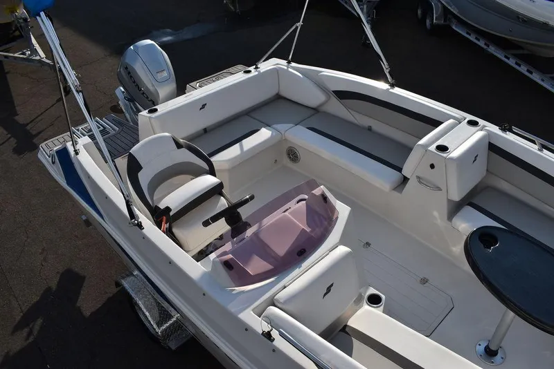 Slide: The Image of 2022 Starcraft SVX 171 boat interior with seating and steering console. - 14