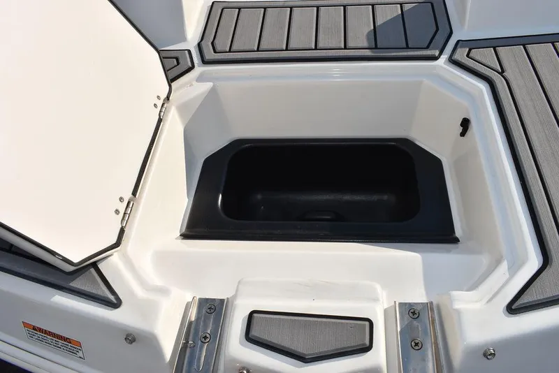Slide: The Image of 2022 Starcraft SVX 171 boat storage compartment with open lid and non-slip flooring. - 21