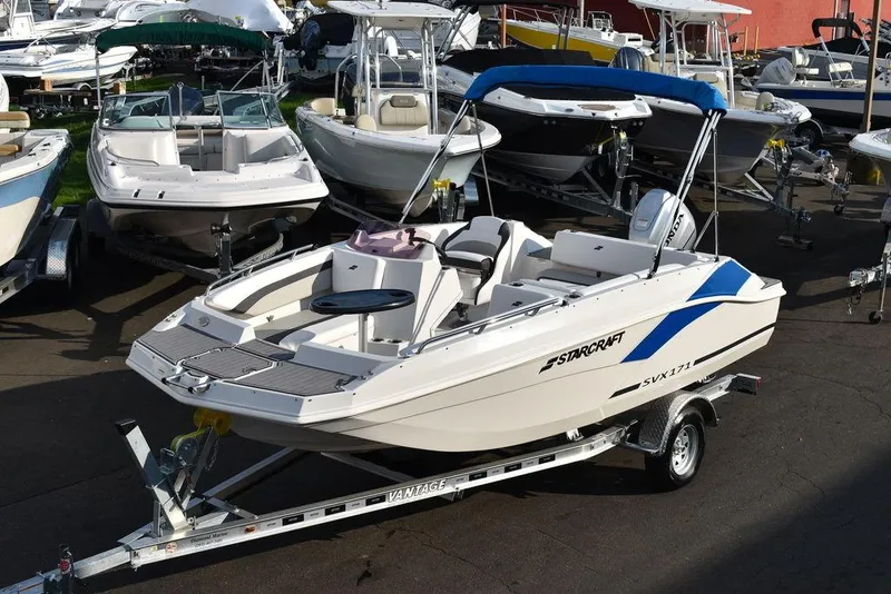 Slide: The Image of 2022 Starcraft SVX 171 boat on trailer, surrounded by other boats in a marina. - 3
