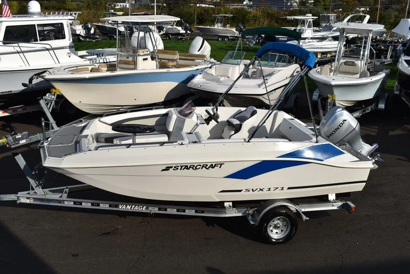 Slide: The Image of 2022 Starcraft SVX 171 boat on trailer, surrounded by other boats in a marina. - 4