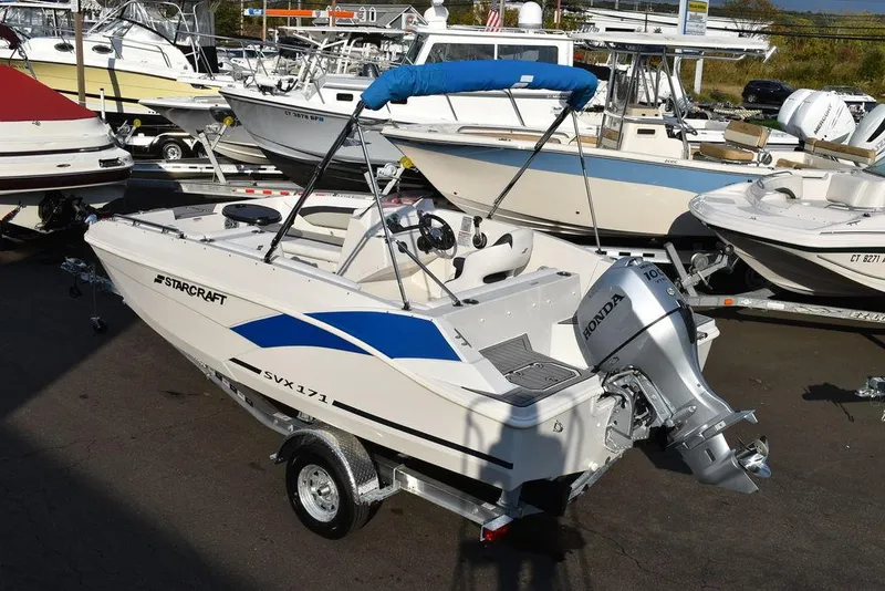 Slide: The Image of 2022 Starcraft SVX 171 boat with Honda outboard motor, displayed in a marina setting. - 5