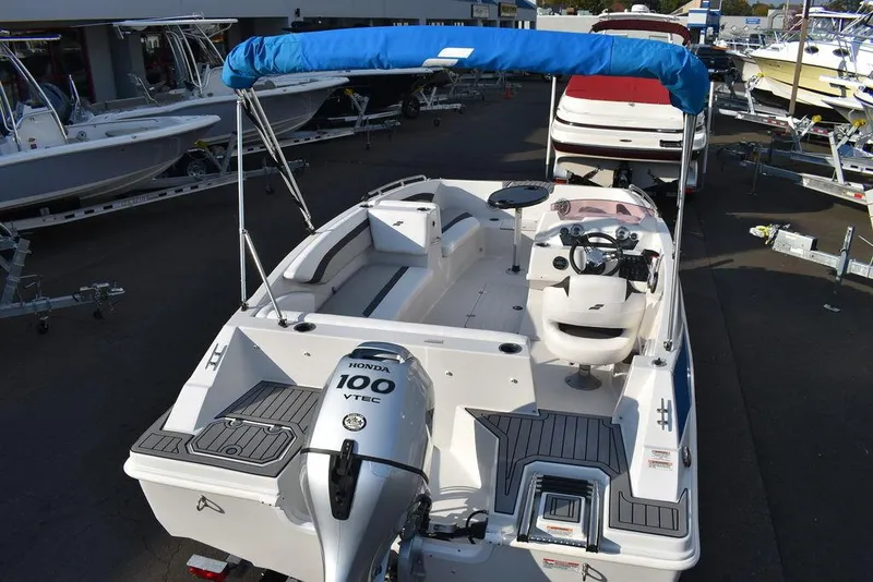 Slide: The Image of 2022 Starcraft SVX 171 boat with Honda 100 VTEC engine, blue canopy, and spacious seating. - 8