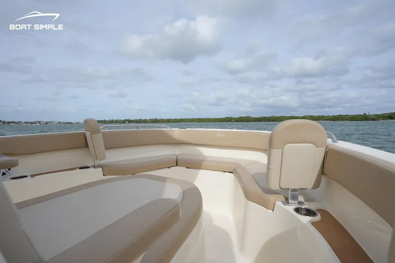 Slide: The Image of 2023 Scout 215 XSF boat interior with beige seating on open water. - 8