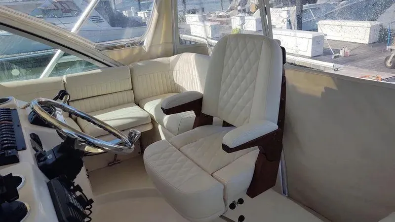 Slide: The Image of 2006 Grady-White Express 360 helm with luxurious white seating and steering wheel. - 11
