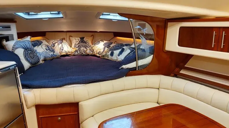 Slide: The Image of Luxurious cabin interior of 2006 Grady-White Express 360 with plush bedding and wood accents. - 15