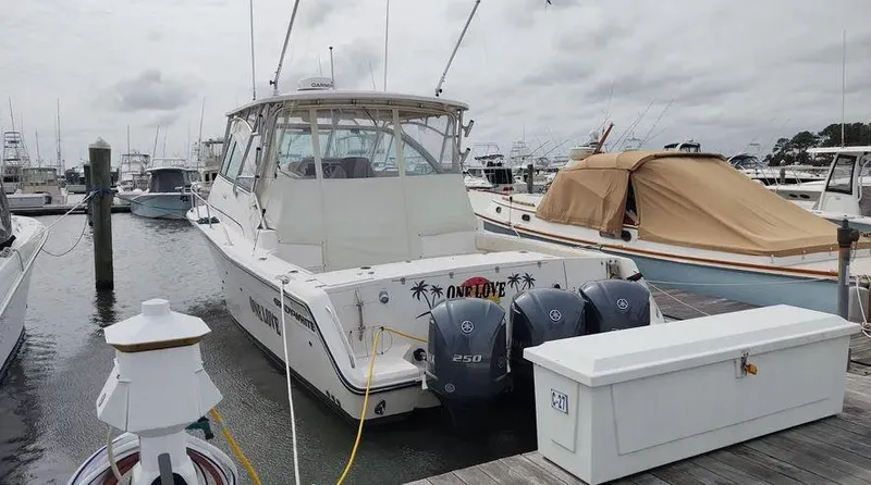 Slide: The Image of 2006 Grady-White Express 360 boat docked with twin outboard engines. - 16