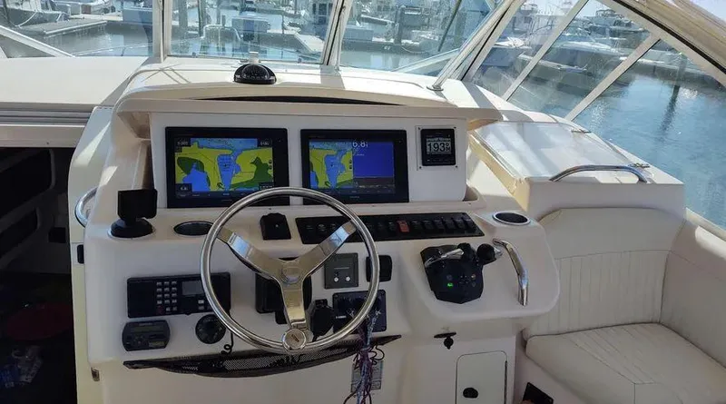 Slide: The Image of 2006 Grady-White Express 360 helm with navigation screens and steering wheel. - 17