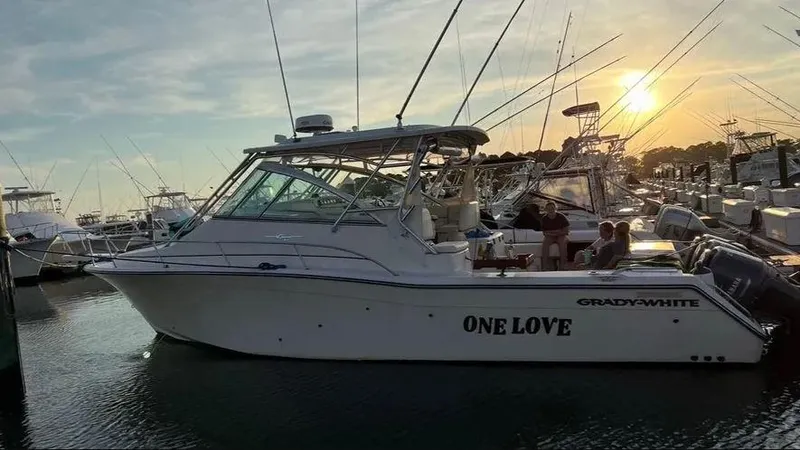 Slide: The Image of 2006 Grady-White Express 360 boat docked at sunset, named "One Love." - 3