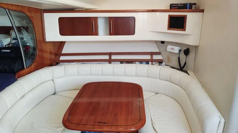 Slide: The Image of Interior of 2006 Grady-White Express 360 with white seating and wooden table. - 5