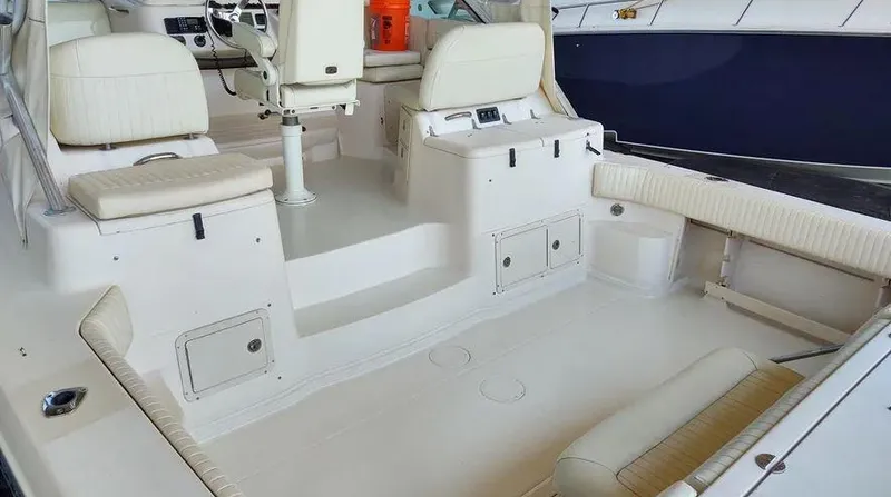 Slide: The Image of 2006 Grady-White Express 360 boat interior with white seating and storage compartments. - 6