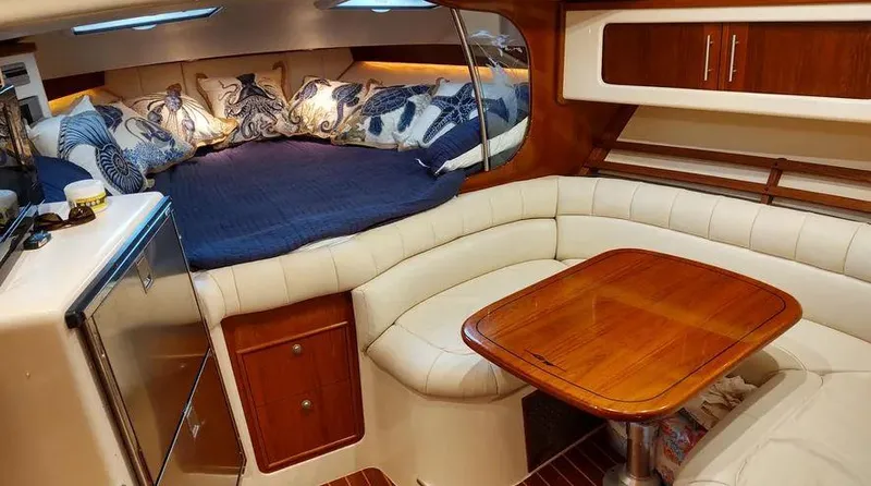 Slide: The Image of Luxurious 2006 Grady-White Express 360 cabin interior with cozy seating and elegant wood finishes. - 8