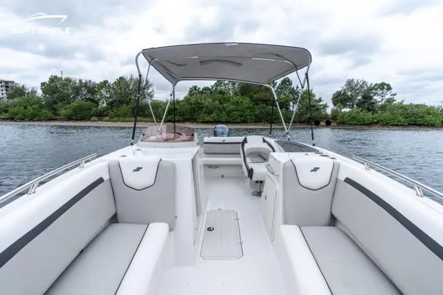 Slide: The Image of 2023 Starcraft SVX 231 OB DH boat interior with canopy on a calm lake. - 9