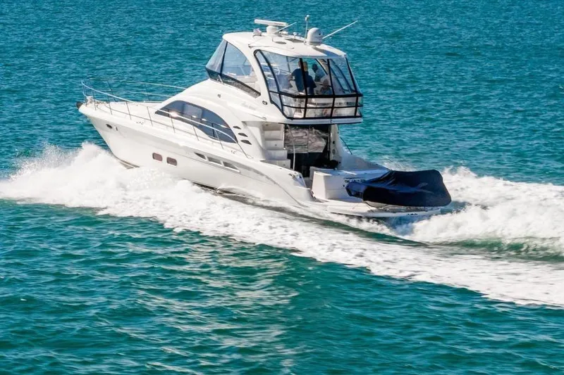 The Image of 2007 Sea Ray 52 Sedan Bridge yacht cruising on open water. - 0