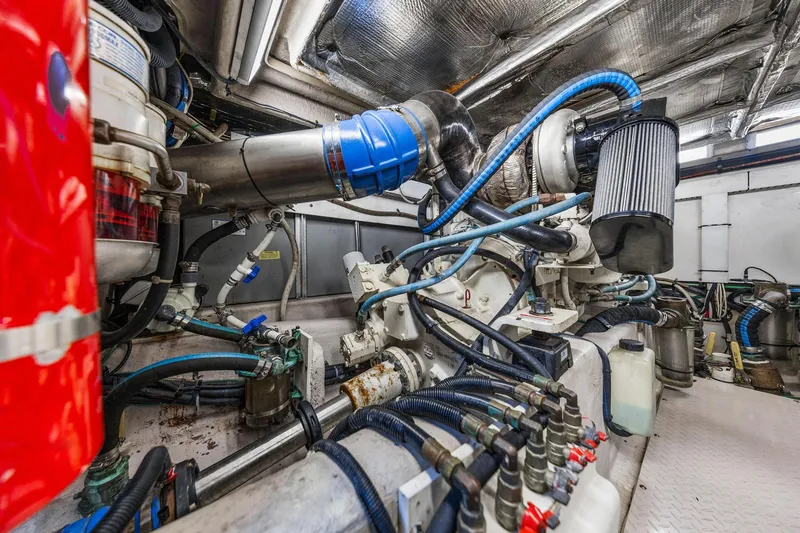 Slide: The Image of Engine room of 2007 Sea Ray 52 Sedan Bridge with complex machinery and wiring. - 17