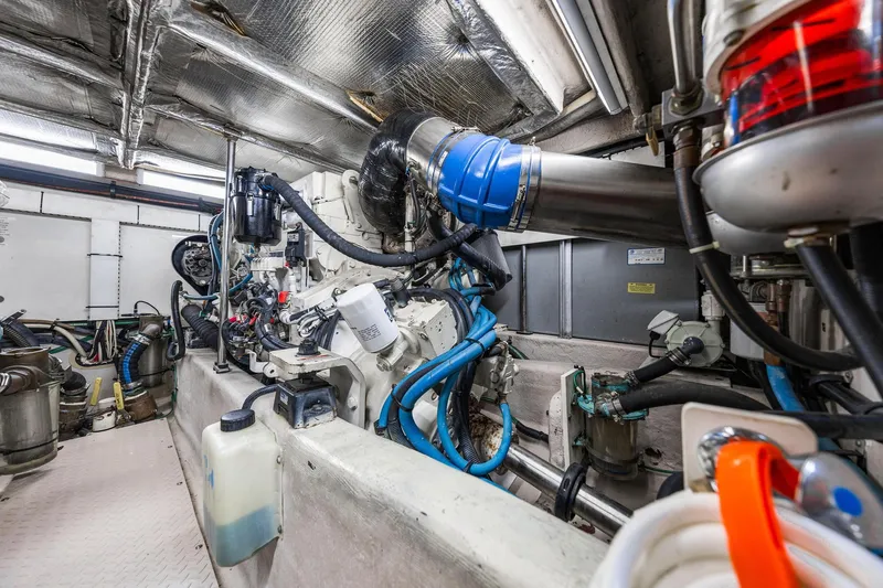 Slide: The Image of Engine room of 2007 Sea Ray 52 Sedan Bridge, showcasing mechanical components and piping. - 18