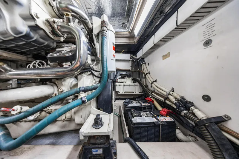 Slide: The Image of Engine room of a 2007 Sea Ray 52 Sedan Bridge with visible batteries and wiring. - 19