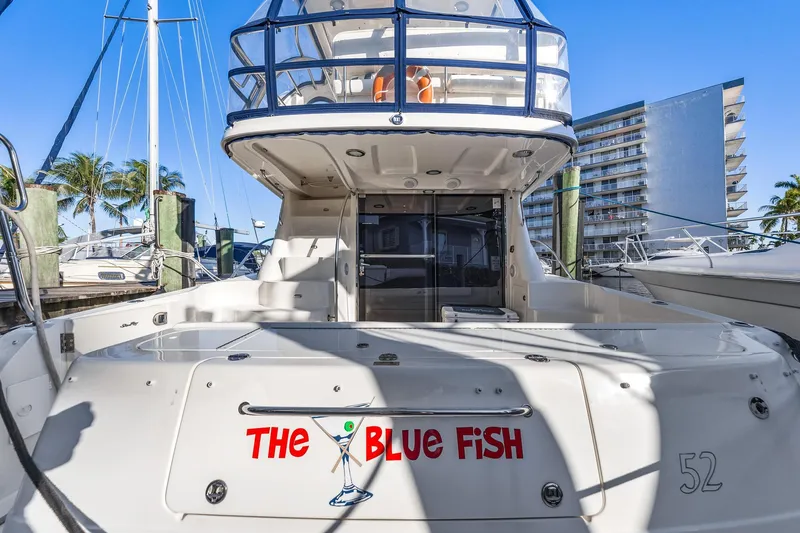 Slide: The Image of 2007 Sea Ray 52 Sedan Bridge yacht docked, named "The Blue Fish." - 23