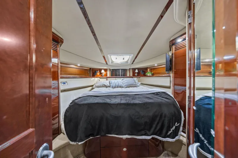 Slide: The Image of Luxurious cabin interior of 2007 Sea Ray 52 Sedan Bridge yacht with elegant wood finishes. - 24