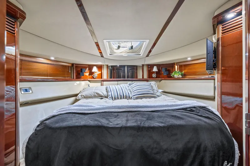 Slide: The Image of Luxurious 2007 Sea Ray 52 Sedan Bridge yacht bedroom with elegant wood finishes and cozy bedding. - 25