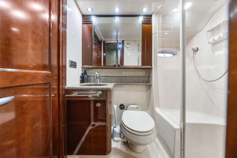 Slide: The Image of Luxurious bathroom in 2007 Sea Ray 52 Sedan Bridge yacht with wood cabinetry and modern fixtures. - 29