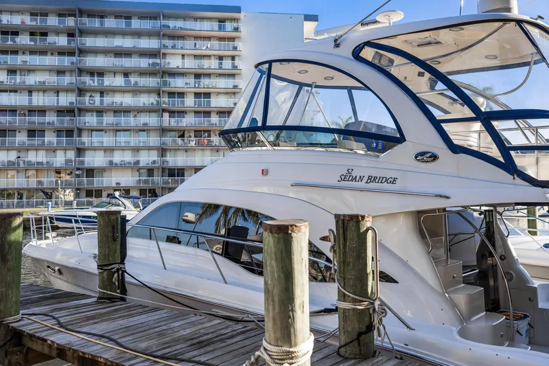 Slide: The Image of 2007 Sea Ray 52 Sedan Bridge yacht docked near waterfront buildings. - 3