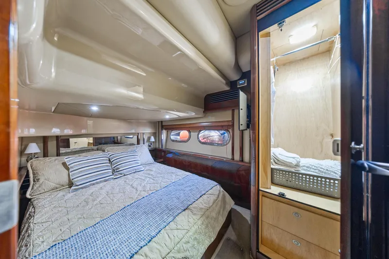 Slide: The Image of Luxurious cabin interior of 2007 Sea Ray 52 Sedan Bridge yacht with cozy bed and storage. - 31