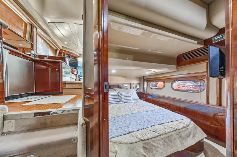 Slide: The Image of Luxurious interior of 2007 Sea Ray 52 Sedan Bridge yacht, featuring a cozy bedroom. - 32