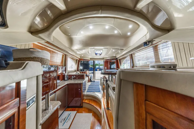 Slide: The Image of Luxurious interior of a 2007 Sea Ray 52 Sedan Bridge yacht, featuring elegant wood finishes. - 35