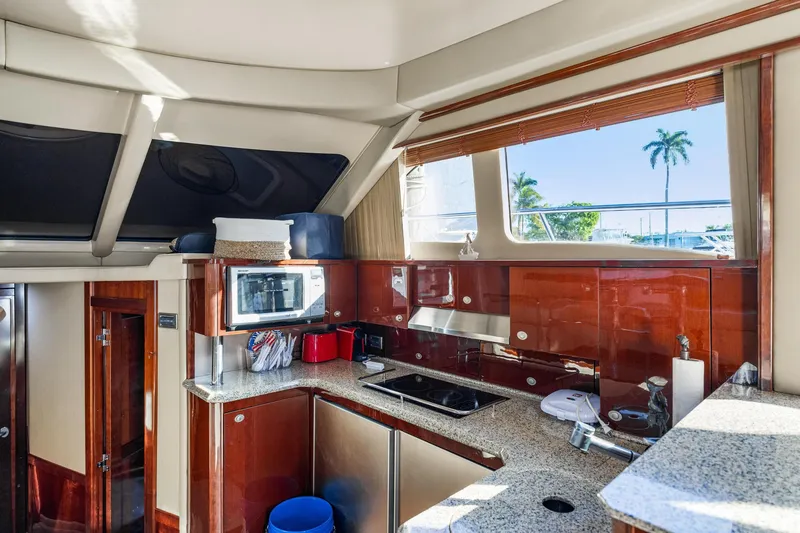 Slide: The Image of Luxurious kitchen interior of 2007 Sea Ray 52 Sedan Bridge yacht with modern amenities. - 39