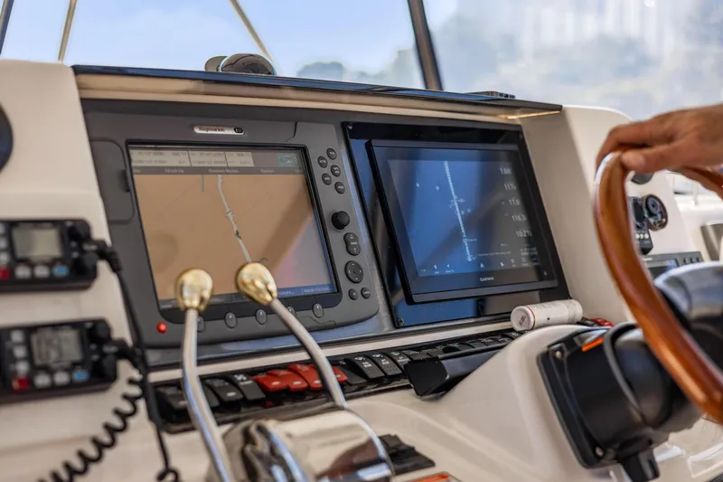 Slide: The Image of 2007 Sea Ray 52 Sedan Bridge helm with navigation screens and controls. - 43