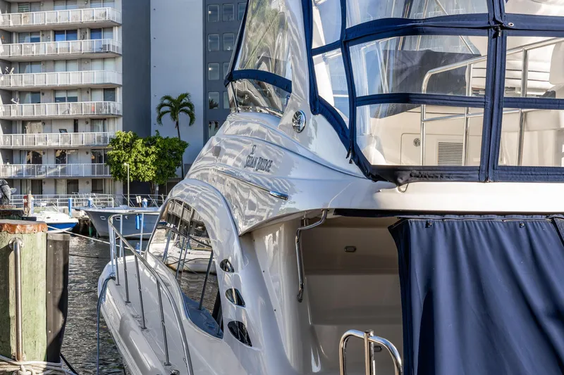 Slide: The Image of 2007 Sea Ray 52 Sedan Bridge yacht docked near waterfront buildings. - 45