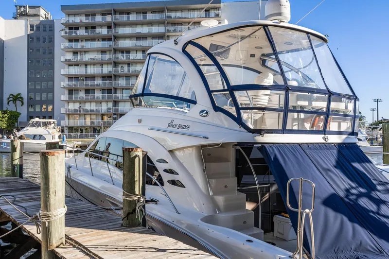 Slide: The Image of 2007 Sea Ray 52 Sedan Bridge yacht docked at marina, with modern design and spacious deck. - 46