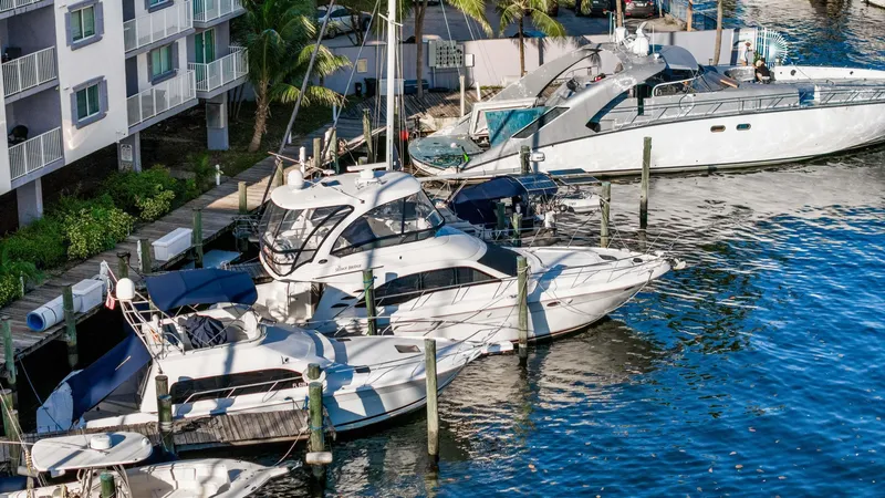 Slide: The Image of 2007 Sea Ray 52 Sedan Bridge yacht docked at marina near waterfront buildings. - 47