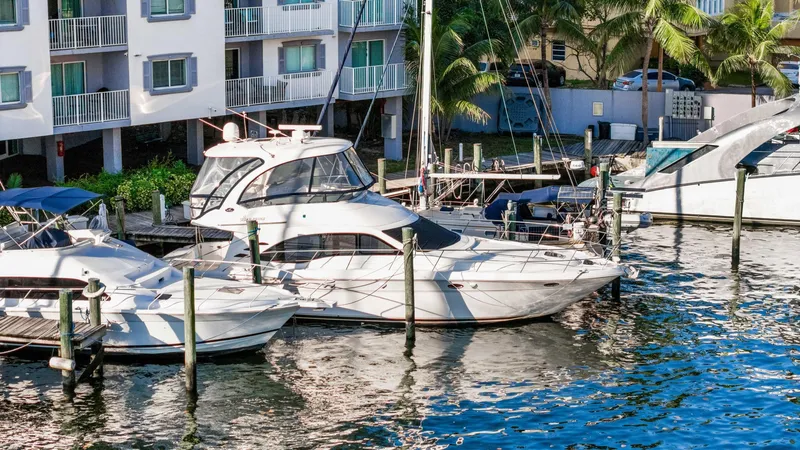 Slide: The Image of 2007 Sea Ray 52 Sedan Bridge yacht docked near waterfront apartments. - 48