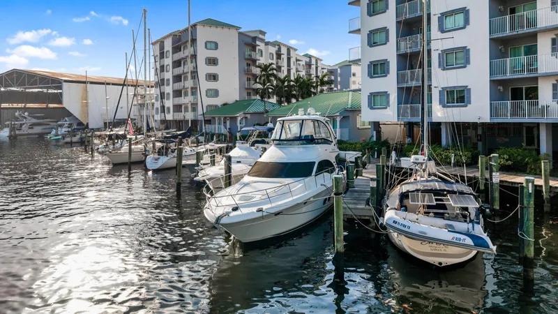 Slide: The Image of 2007 Sea Ray 52 Sedan Bridge yacht docked near waterfront apartments. - 49