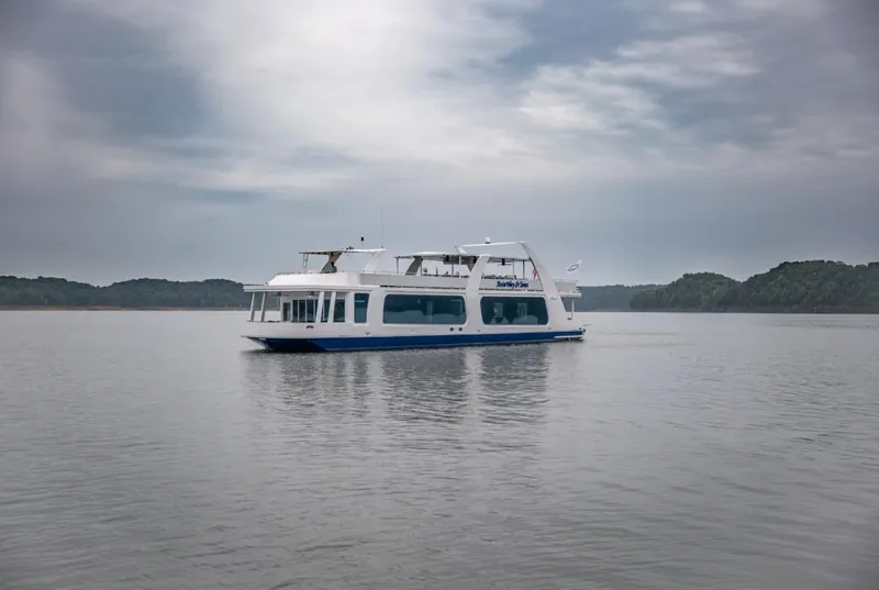 Slide: The Image of 2020 Thoroughbred houseboat on calm lake under cloudy sky. - 2