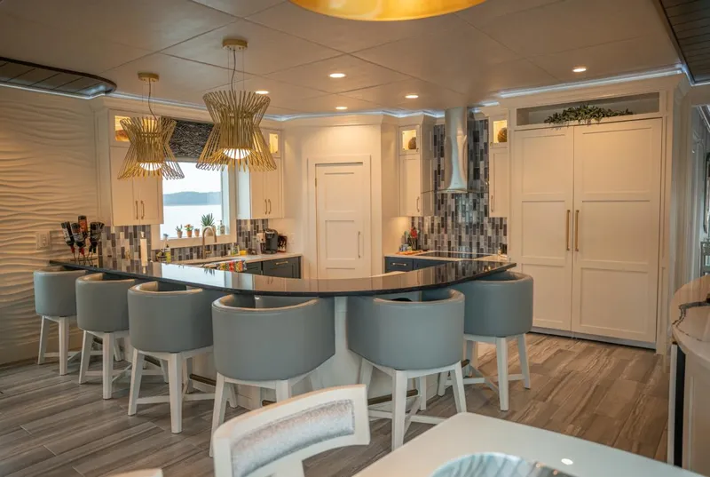 Slide: The Image of Luxurious 2020 Thoroughbred houseboat kitchen with modern design, elegant lighting, and stylish seating. - 3