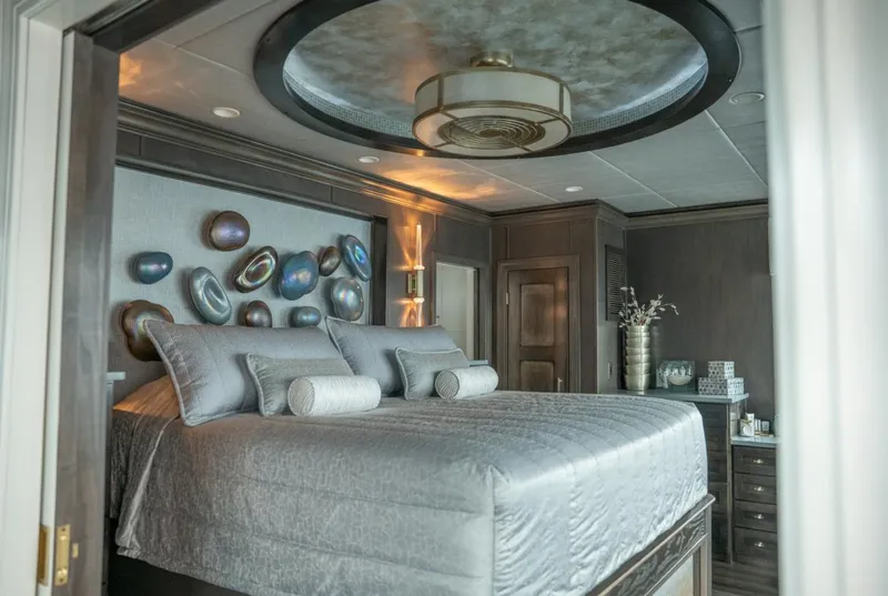 Slide: The Image of Luxurious bedroom interior on a 2020 Thoroughbred houseboat, featuring elegant decor and modern furnishings. - 7