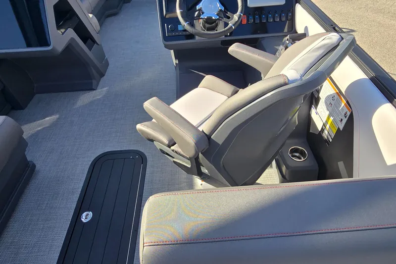 Slide: The Image of 2025 Manitou 240 Cruise boat interior with modern steering and seating. - 12