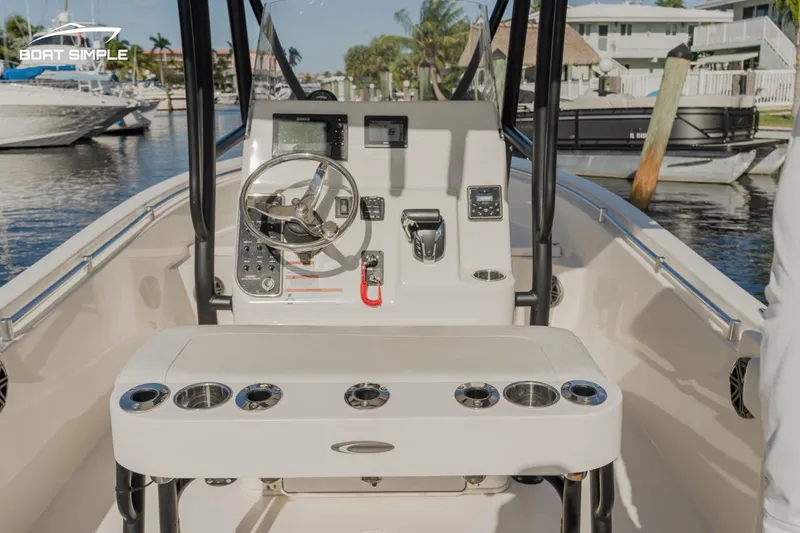 Slide: The Image of 2023 Cobia 220 Center Console boat interior with steering wheel and control panel. - 6